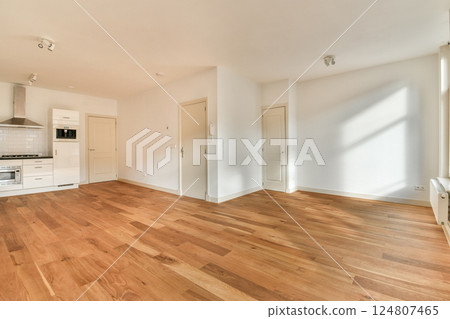An inviting interior showcasing a modern apartment with ample natural light, hardwood floors, and minimalist design elements that create a warm atmosphere. An inviting interior showcasing a modern apartment with ample natural light, hardwood floors, and minimalist design elements that create a warm atmosphere. 124807465