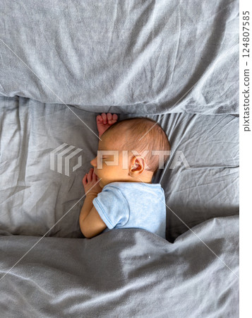 Newborn Baby Sleeping Peacefully on Bed Newborn Baby Sleeping Peacefully on Bed 124807585