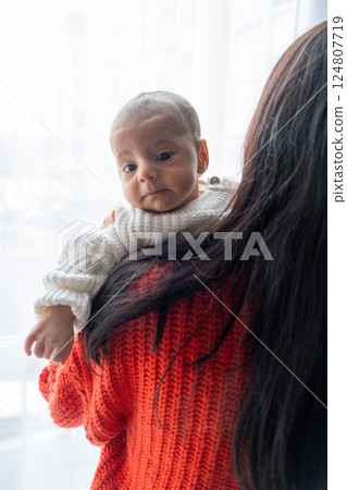 Tender Moment Between Mother and Baby by the Window 124807719