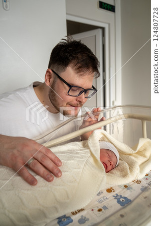 Father Adoring His Newborn Baby in Hospital 124807728
