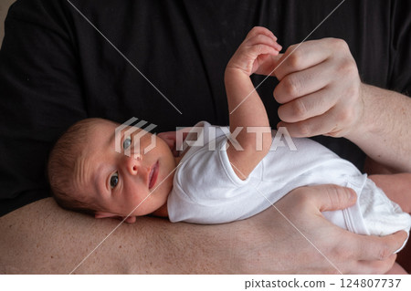 Newborn Baby Cradled in Hand 124807737