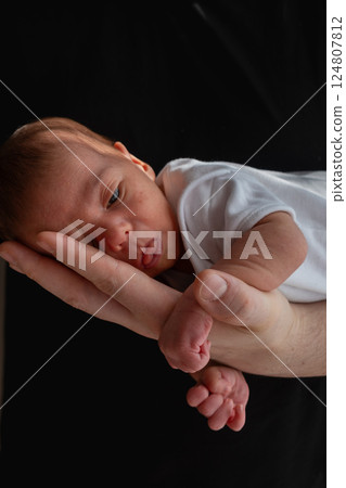 Newborn Baby Cradled in Hand 124807812