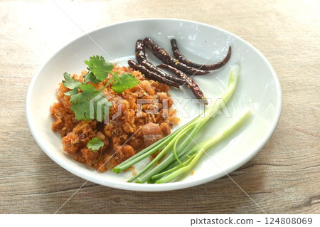 fried chop dry pickled fish taste sour and salty topping chili with slice spring onion on plate fried chop dry pickled fish taste sour and salty topping chili with slice spring onion on plate 124808069
