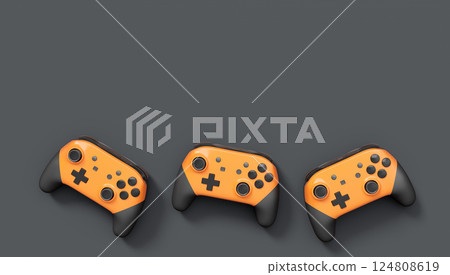 Realistic orange video game joysticks or gamepads on black background 124808619