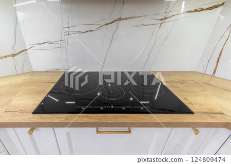 Modern Induction Cooktop on Wooden Countertop Modern Induction Cooktop on Wooden Countertop 124809474