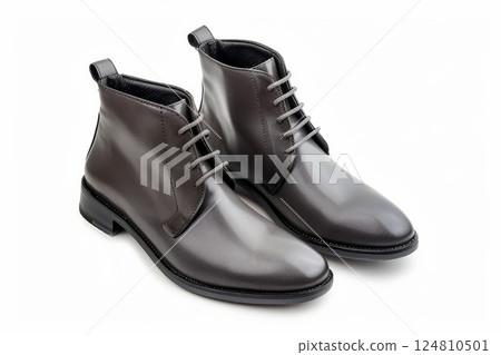 Pair of classic black leather boots with a textured rubber sole, isolated against white. 124810501
