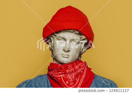 Antique statue of a young man in a red hipster hat and cowboy shirt 124811127