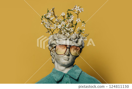 Classical white bust with a blooming tree branch sprouting from his head. Classical white bust with a blooming tree branch sprouting from his head. 124811130