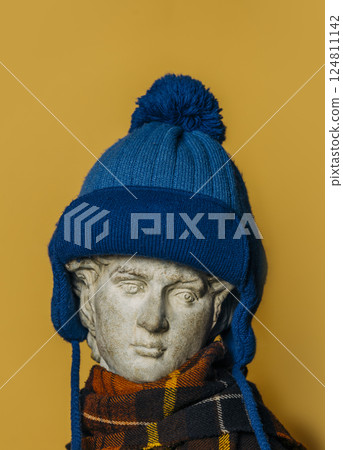 antique statue of a young man wearing a blue winter hat antique statue of a young man wearing a blue winter hat 124811142