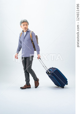 Full-body photo of a senior man walking with a carry bag 124811496