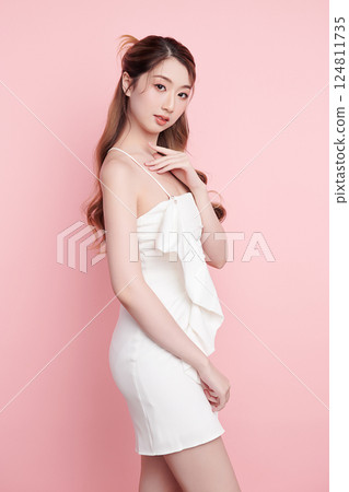 Beautiful face of young Asian woman in sexy dress white Perfect slim body on pink background, plastic surgery and aesthetic cosmetology, Facial and skin care concept 124811735