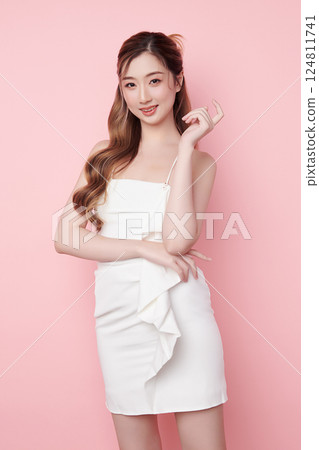 Beautiful face of young Asian woman in sexy dress white Perfect slim body on pink background, plastic surgery and aesthetic cosmetology, Facial and skin care concept 124811741