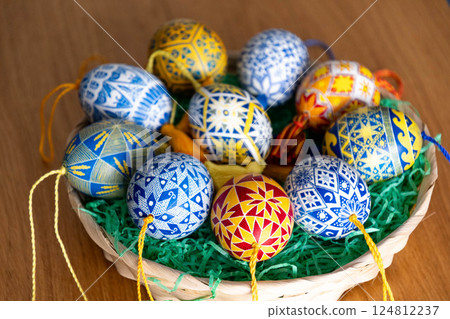 Colorful Easter eggs in a basket showcasing traditional Ukrainian pysanky with intricate folk patterns for a festive celebration 124812237