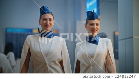 Portrait of Two Beautiful Stewardesses Smiling, Looking at Camera 124812247