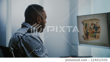 Airport Security Checkpoint: TSA Worker Controlling Scanning of Luggage on Computer Monitors Airport Security Checkpoint: TSA Worker Controlling Scanning of Luggage on Computer Monitors 124812430