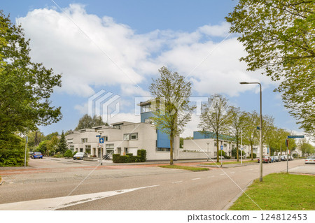 A vibrant city scene featuring modern architecture, clear skies, and lush greenery along the streets, showcasing a harmonious blend of nature and urban living. 124812453