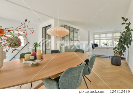 A stylish and inviting interior featuring a large wooden dining table, elegant decor, and vibrant plants, creating a warm and homey atmosphere. A stylish and inviting interior featuring a large wooden dining table, elegant decor, and vibrant plants, creating a warm and homey atmosphere. 124812489