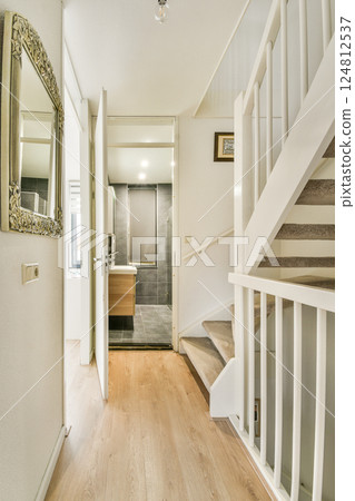 Bright and airy hallway showcasing contemporary design elements and a stylish staircase, enhancing the feeling of space and light. 124812537