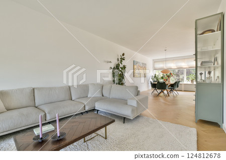 A stylish modern living room featuring a comfortable sofa, decorative plants, and warm lighting, creating a cozy and inviting atmosphere for relaxation. A stylish modern living room featuring a comfortable sofa, decorative plants, and warm lighting, creating a cozy and inviting atmosphere for relaxation. 124812678