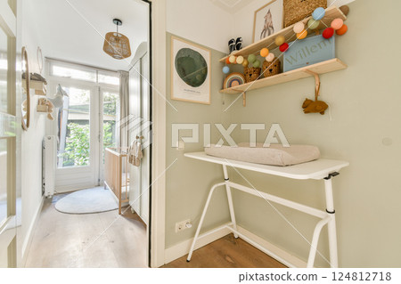 A stylish entryway featuring light green walls, modern decor, and a cozy atmosphere. The space includes plants, art, and clever storage solutions. A stylish entryway featuring light green walls, modern decor, and a cozy atmosphere. The space includes plants, art, and clever storage solutions. 124812718
