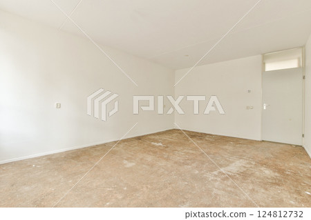 A vacant room featuring white walls and a bare concrete floor, showcasing a minimalist and spacious atmosphere. Perfect for renovation ideas. A vacant room featuring white walls and a bare concrete floor, showcasing a minimalist and spacious atmosphere. Perfect for renovation ideas. 124812732