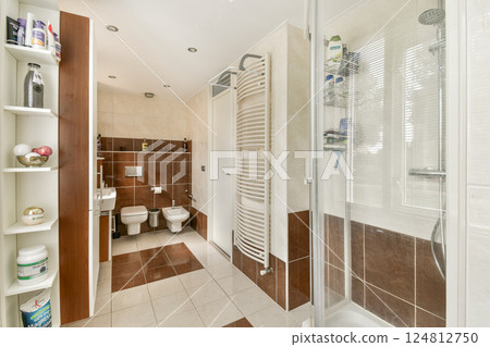 This contemporary bathroom features sleek fixtures, elegant tile work, and an organized layout, contributing to a clean and relaxing atmosphere. This contemporary bathroom features sleek fixtures, elegant tile work, and an organized layout, contributing to a clean and relaxing atmosphere. 124812750