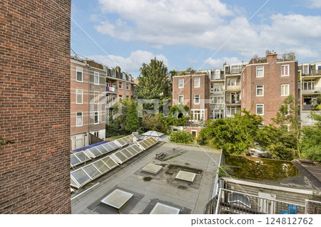 A view showcasing modern urban buildings integrated with greenery, highlighting the blend of nature and contemporary design in city life. A view showcasing modern urban buildings integrated with greenery, highlighting the blend of nature and contemporary design in city life. 124812762