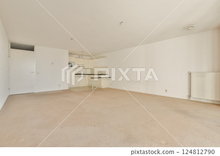 Spacious, modern living room with beige carpet, white walls, and minimalist design. Ideal for home staging or interior decor inspiration. Spacious, modern living room with beige carpet, white walls, and minimalist design. Ideal for home staging or interior decor inspiration. 124812790