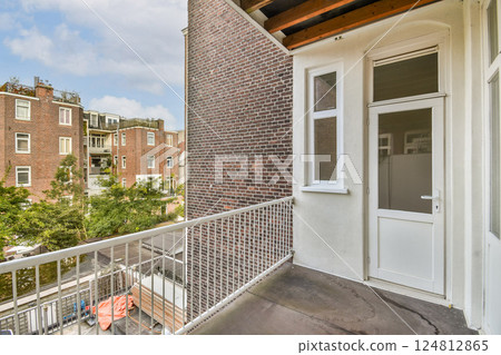 A contemporary balcony showcasing a blend of urban architecture with greenery visible from the outdoor space, highlighting a serene city atmosphere. A contemporary balcony showcasing a blend of urban architecture with greenery visible from the outdoor space, highlighting a serene city atmosphere. 124812865