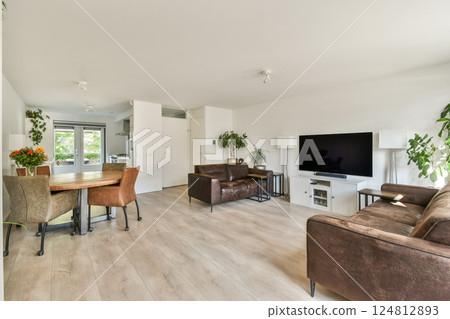 Stylish and spacious living room featuring modern furniture, ample natural light, and a cozy atmosphere, perfect for relaxation and social gatherings. Stylish and spacious living room featuring modern furniture, ample natural light, and a cozy atmosphere, perfect for relaxation and social gatherings. 124812893