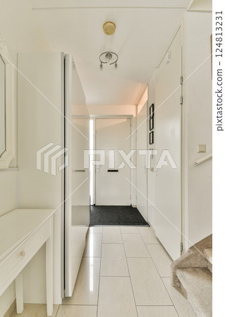 Bright and spacious hallway showcasing modern design elements, featuring a sleek console table, contemporary doors, and clean lines that invite natural light. Bright and spacious hallway showcasing modern design elements, featuring a sleek console table, contemporary doors, and clean lines that invite natural light. 124813231
