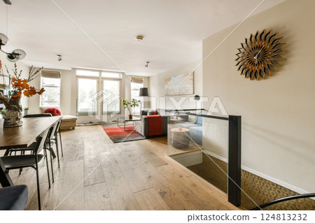 A stylish dining area featuring a modern design with wooden flooring, minimalistic furniture, and tasteful decorations, creating a warm and inviting atmosphere. 124813232