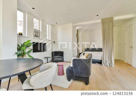 A serene and stylish interior featuring a living space with a cozy theme, plants, and minimalist furniture that promotes relaxation and comfort. 124813236