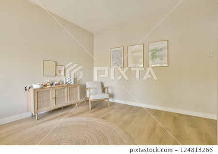 A serene and contemporary interior featuring a light-colored room, stylish furniture, and decorative art. Ideal for creating a calm atmosphere and aesthetic appeal. 124813266