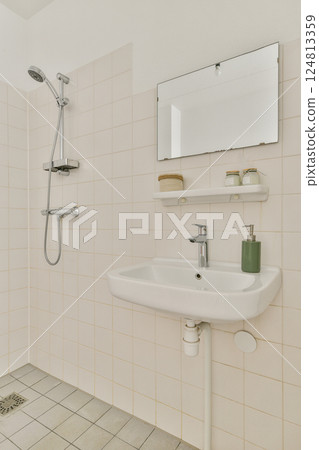 A clean and modern bathroom featuring a simple sink, shower, and minimal decor. The design emphasizes functionality and a sleek aesthetic. A clean and modern bathroom featuring a simple sink, shower, and minimal decor. The design emphasizes functionality and a sleek aesthetic. 124813359