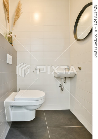 Elegant and clean bathroom featuring a minimalist aesthetic with neutral tiles and modern fixtures, showcasing a spacious layout for comfort and style. Elegant and clean bathroom featuring a minimalist aesthetic with neutral tiles and modern fixtures, showcasing a spacious layout for comfort and style. 124813429