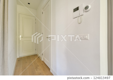 A sleek and modern hallway showcasing minimalistic design elements, clean lines, and a bright atmosphere emanating from natural light. A sleek and modern hallway showcasing minimalistic design elements, clean lines, and a bright atmosphere emanating from natural light. 124813497