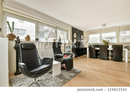 A sleek and contemporary living space featuring elegant furniture, a cozy atmosphere, and ample natural light, ideal for modern living and comfort. A sleek and contemporary living space featuring elegant furniture, a cozy atmosphere, and ample natural light, ideal for modern living and comfort. 124813541