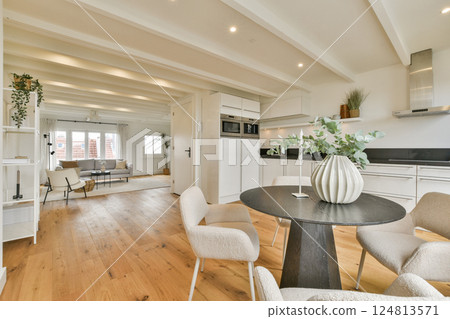 A stylish and contemporary interior featuring elegant furniture, soft colors, and natural light, creating a serene living space perfect for relaxation. 124813571