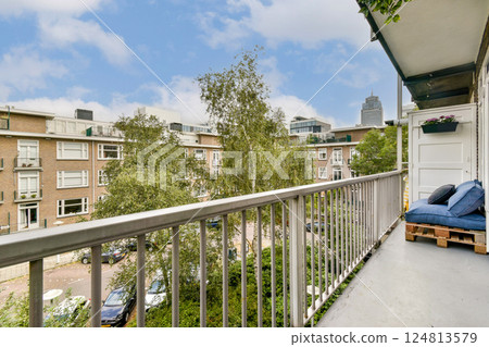 A stylish modern balcony featuring wooden seating and a lush green view, perfect for enjoying the urban skyline and surrounding greenery. 124813579