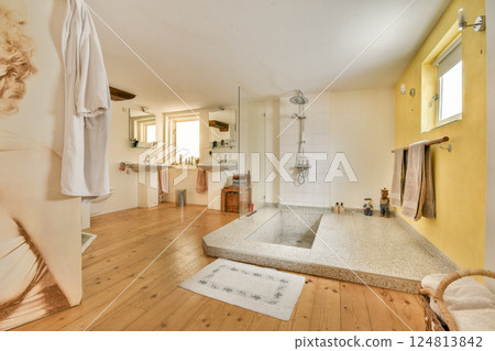A contemporary bathroom featuring a spacious layout, elegant fixtures, and warm colors, providing a soothing ambiance for relaxation. A contemporary bathroom featuring a spacious layout, elegant fixtures, and warm colors, providing a soothing ambiance for relaxation. 124813842
