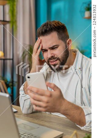 Business man using smartphone bad news lottery game results fortune loss fail at home office 124813932