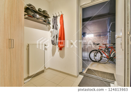 A contemporary entryway showcasing a bicycle, sports apparel, and a combination of functional decor for an inviting space. A contemporary entryway showcasing a bicycle, sports apparel, and a combination of functional decor for an inviting space. 124813983