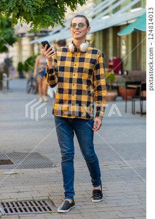 Man using smartphone typing texting social media messages looking for a way on map navigator app Man using smartphone typing texting social media messages looking for a way on map navigator app 124814013