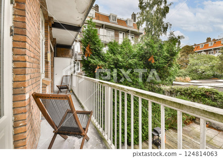 A charming balcony scene showcasing modern architecture accented by lush greenery and stylish seating, ideal for relaxation and outdoor living. A charming balcony scene showcasing modern architecture accented by lush greenery and stylish seating, ideal for relaxation and outdoor living. 124814063