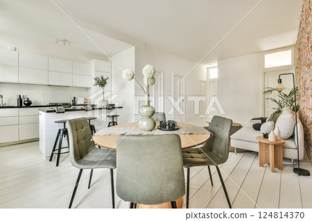 A sleek and contemporary living space featuring a stylish dining area, ergonomic furniture, and elegant decor that emphasizes simplicity and functionality. A sleek and contemporary living space featuring a stylish dining area, ergonomic furniture, and elegant decor that emphasizes simplicity and functionality. 124814370