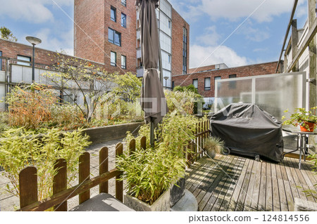 A serene outdoor garden featuring modern architecture, lush plants, and a designed seating area for relaxation and enjoyment amidst nature. A serene outdoor garden featuring modern architecture, lush plants, and a designed seating area for relaxation and enjoyment amidst nature. 124814556