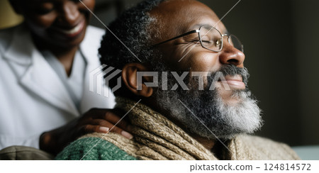 smiling elderly man with glasses enjoys comforting moment with healthcare professional 124814572