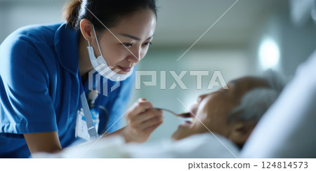 caring healthcare professional in blue uniform assists elderly patient with warm smile 124814573