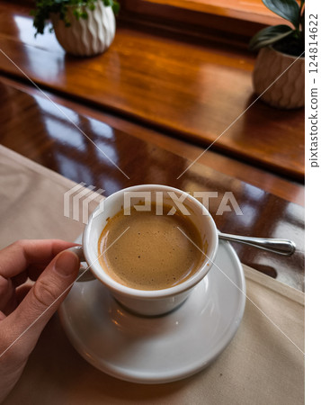 Tourist enjoying a cup of coffee Lungo in prague cafe Tourist enjoying a cup of coffee Lungo in prague cafe 124814622
